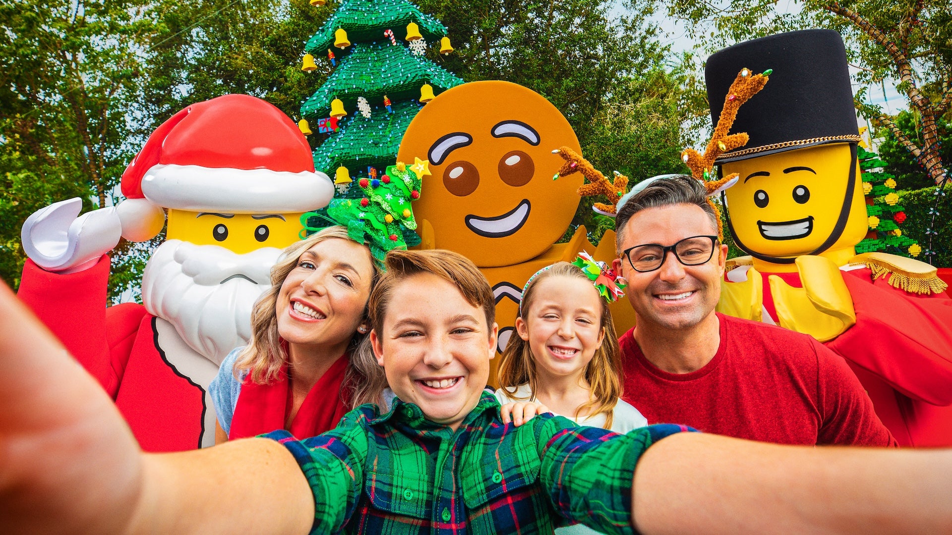 Family taking a selfie with three Christmas lego characters